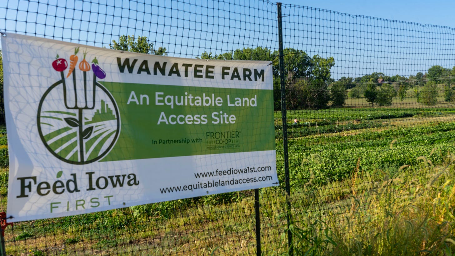 A fenced in field with a sign on it with the words 'Wanatee Farm An Equitable Land Access Site'. A fenced in field with a sign on it with the words 'Wanatee Farm An Equitable Land Access Site'.