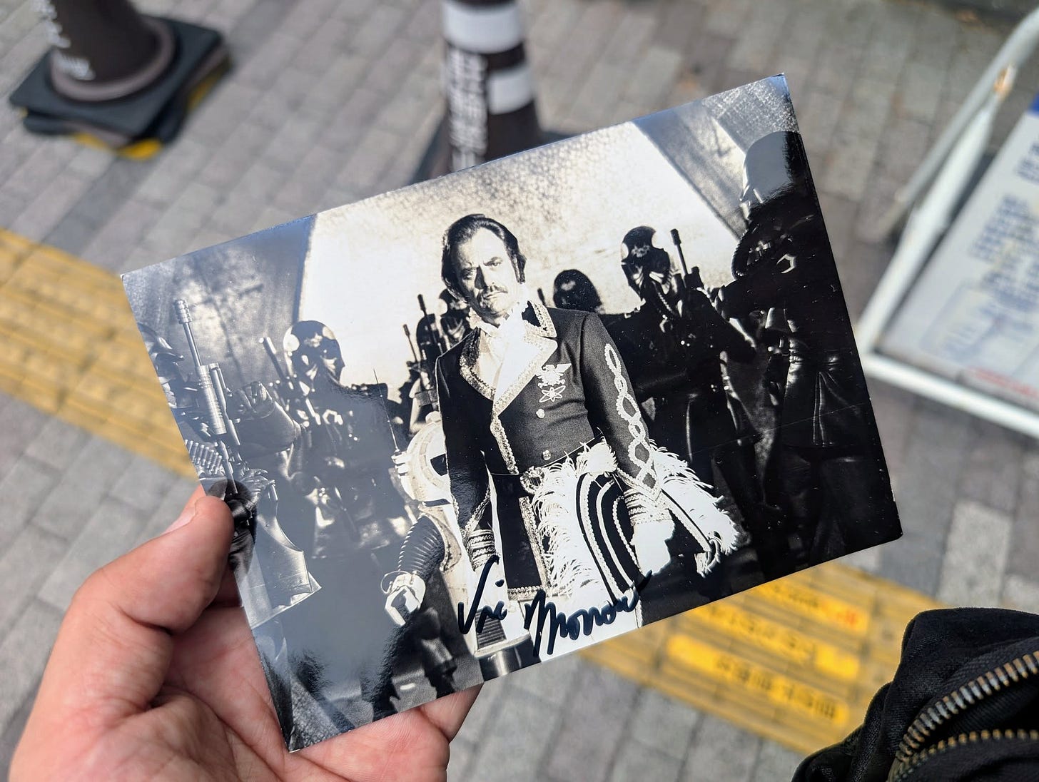 May be an image of 1 person, street and text May be an image of 1 person, street and text