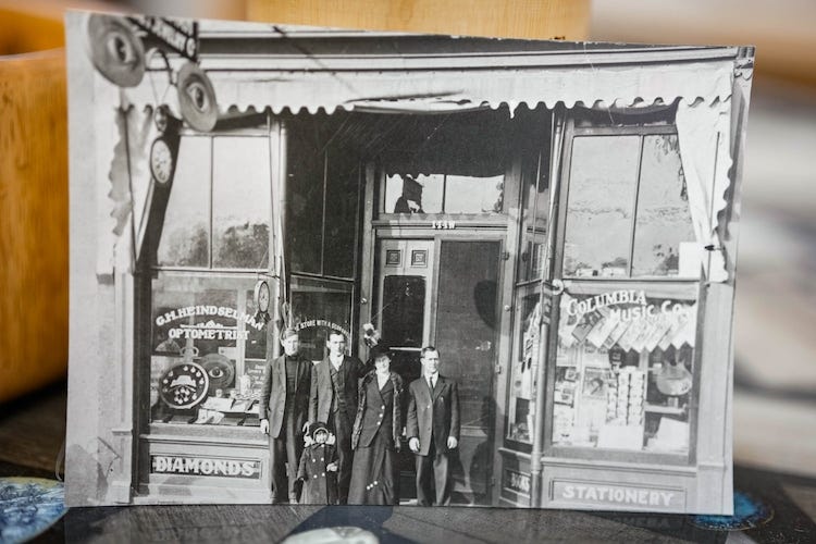 (Francisco Kjolseth | The Salt Lake Tribune) A 1913 photograph depicts the beginnings of what is now Heindselman's Yarn and Needlework shop in Provo. The shop began doing business in 1904 in a corner of a drugstore where George “Doc” Heindselman, center left, made eyeglasses for residents. Later, Doc’s wife, Dee, at his side with daughter Erma, began stocking yarn and embroidery supplies.
