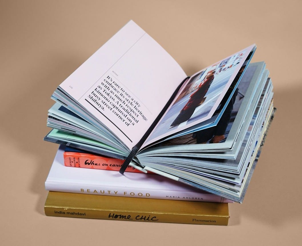 open book on top of several stacked books open book on top of several stacked books