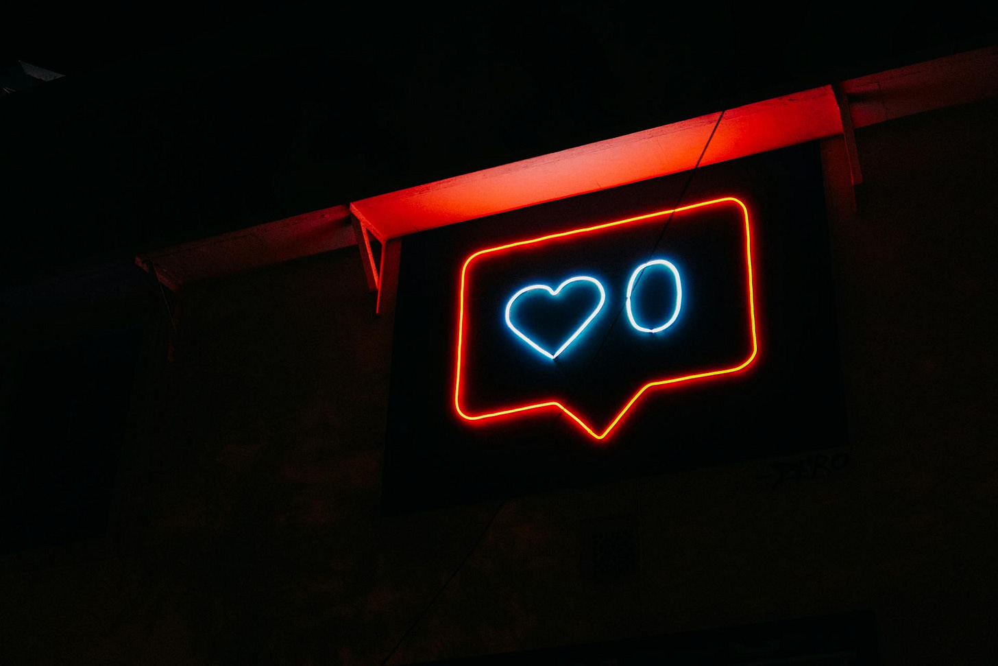 Neon red sign of a social media "Love" icon and the number 0 next to it Neon red sign of a social media "Love" icon and the number 0 next to it