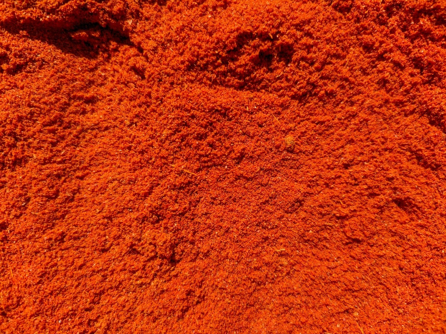 a close up of a pile of red dirt
