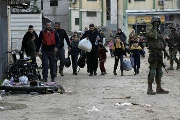 Residents evacuate Al-Faraa refugee camp, West Bank, earlier this month.