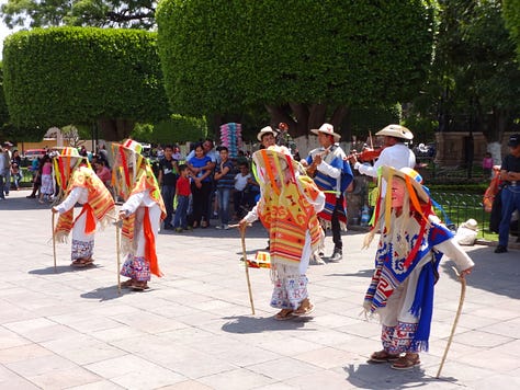 Images of dancing old men, the island by Patzcuaro, and the monument.