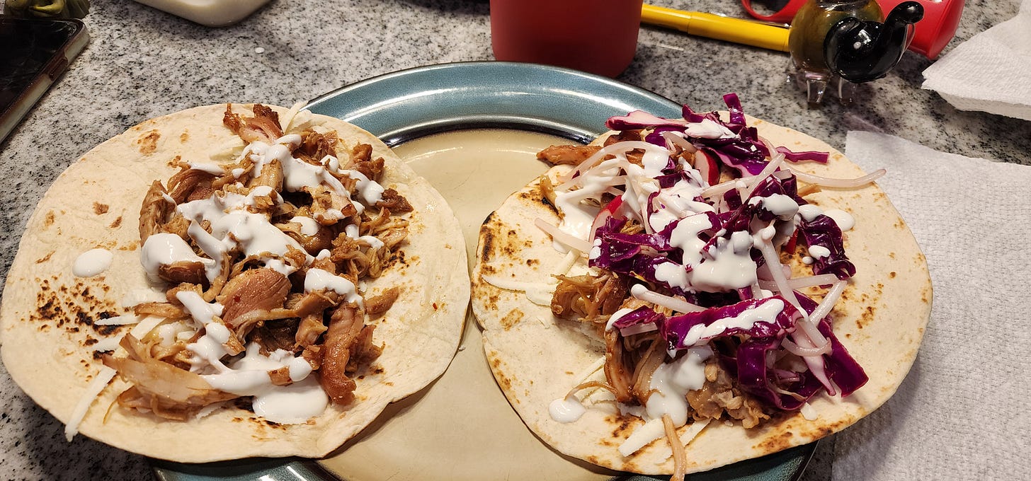 two open chicken bulogi tacos with shredded meat, white sauce, and pickled veg two open chicken bulogi tacos with shredded meat, white sauce, and pickled veg
