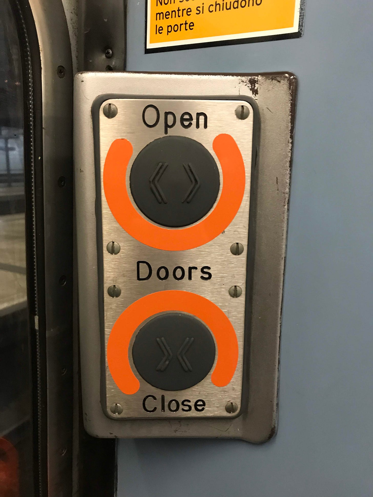 Photo showing a set of door opening buttons on a former Stansted Express Class 317 train, which has since been retired and scrapped. 