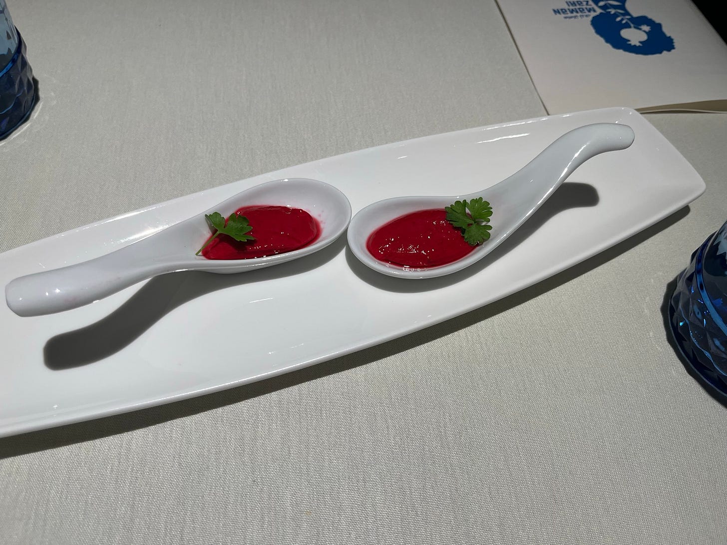 Beet-red pudding with parsley on big spoons Beet-red pudding with parsley on big spoons