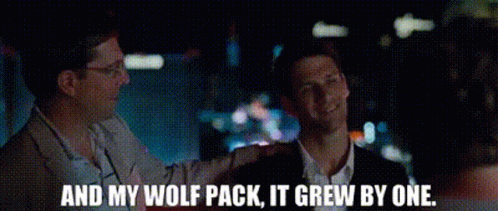 two men are standing next to each other with the words and my wolf pack it grew by one .