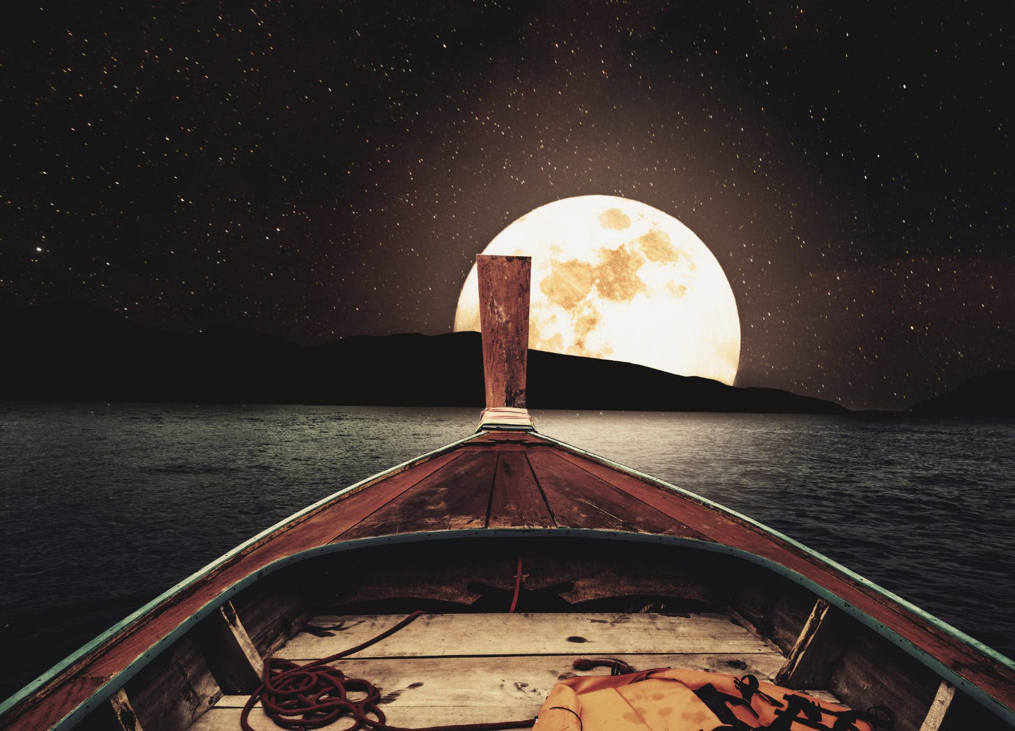 View from the bow of a vintage wooden boat at night, with a full moon and stars lighting the horizon—suggesting wonder, whimsy, and quiet longing.