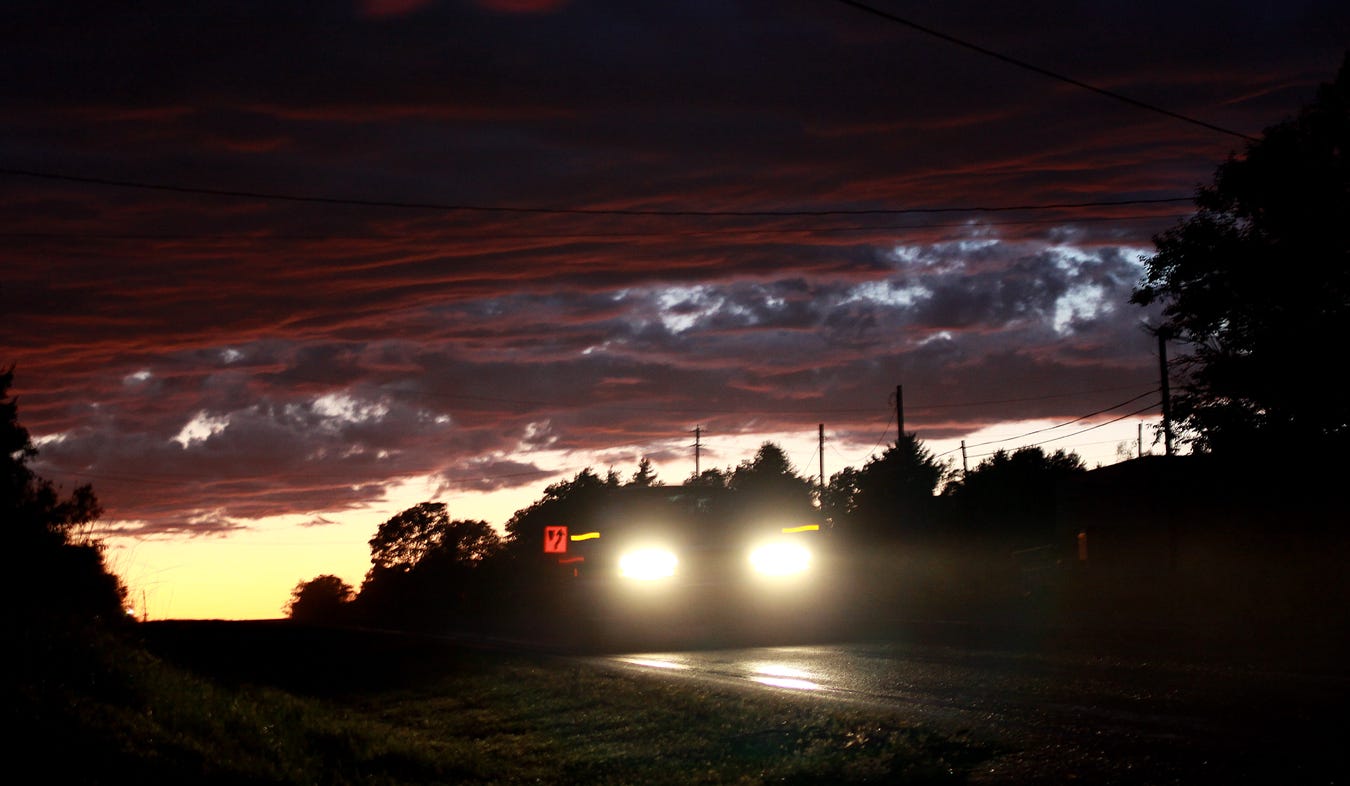 Sometimes a thoughtfully angled photograph can bring two sources of interesting light into one frame, creating an interesting photo from mundane subjects. An eastbound car on U.S. 40 speeds past the lens, while, behind it, a setting sun evokes striking colors on interesting clouds.
