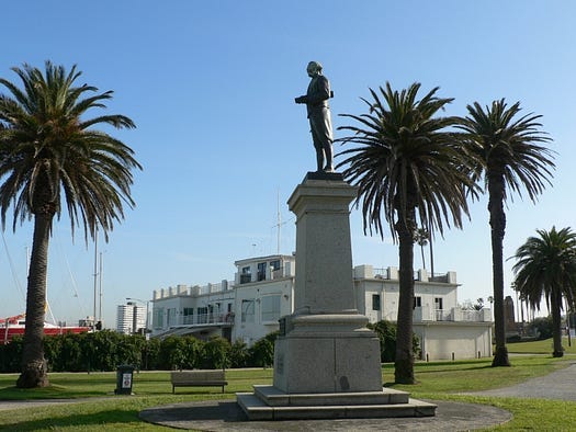 Statue and plinth on palm treed foreshore Statue and plinth on palm treed foreshore