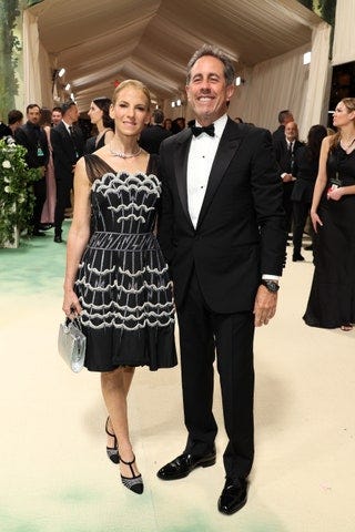 Image may contain Jerry Seinfeld Jessica Seinfeld Clothing Formal Wear Suit Person Blazer Coat Jacket and Adult