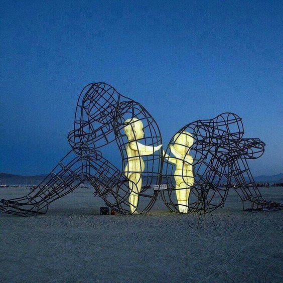 This may contain: a large metal sculpture sitting on top of a sandy beach next to a blue sky