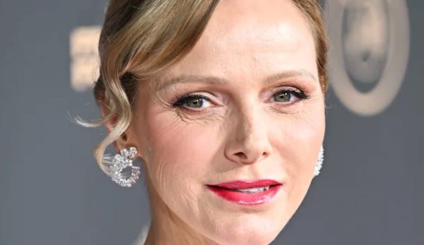 Princess Charlene smiling wearing makeup and sparkly earings