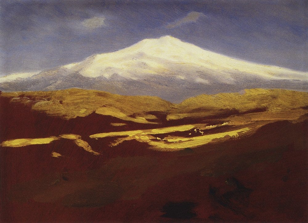 The snowy twin summit of Mount Elbrus glowing above haze The snowy twin summit of Mount Elbrus glowing above haze