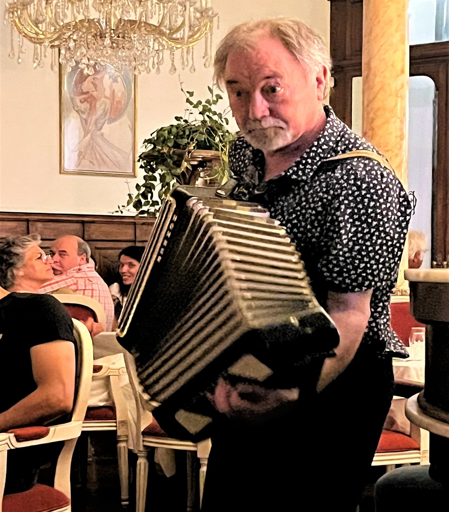 A person holding an accordion

Description automatically generated
