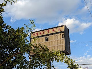 Image of the ruined hotel sign as seen from below