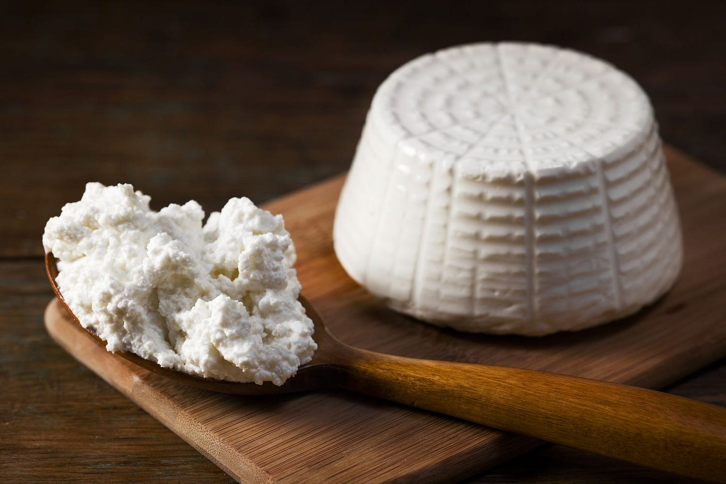 Ricotta Cheese on wooden board and spoon