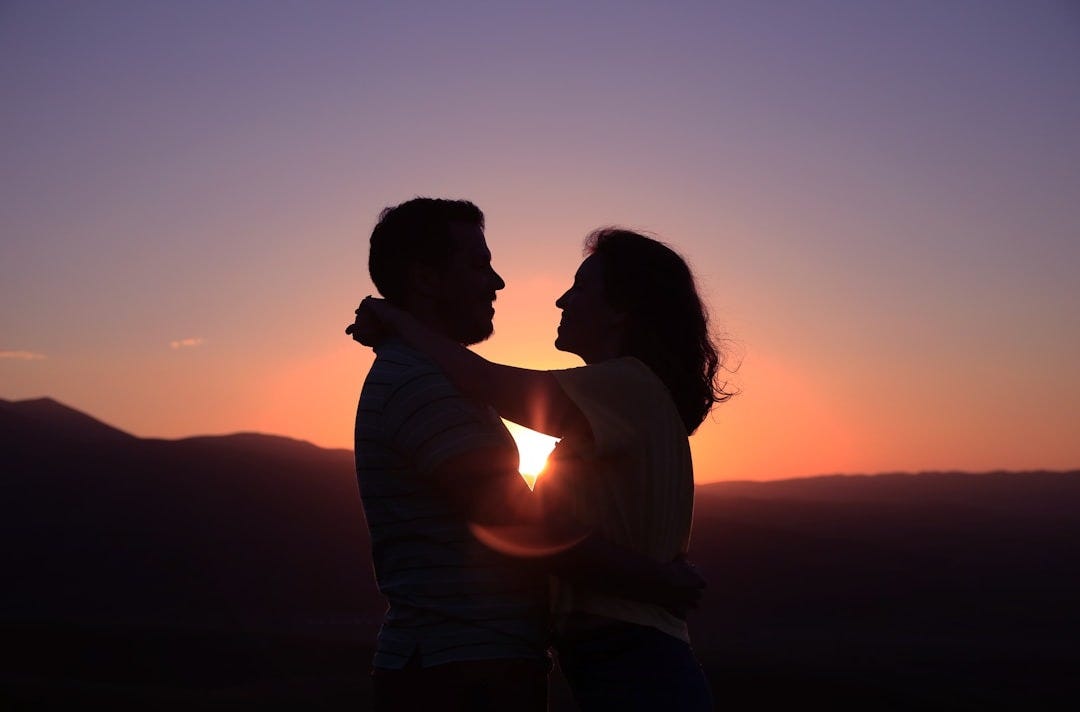 silhouette of hugging couple
