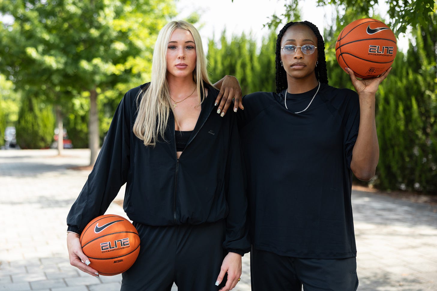 Chloe Kitts and Joyce Edwards pose with Nike basketballs as part of Nike Blue Ribbon Elite NIL roll out