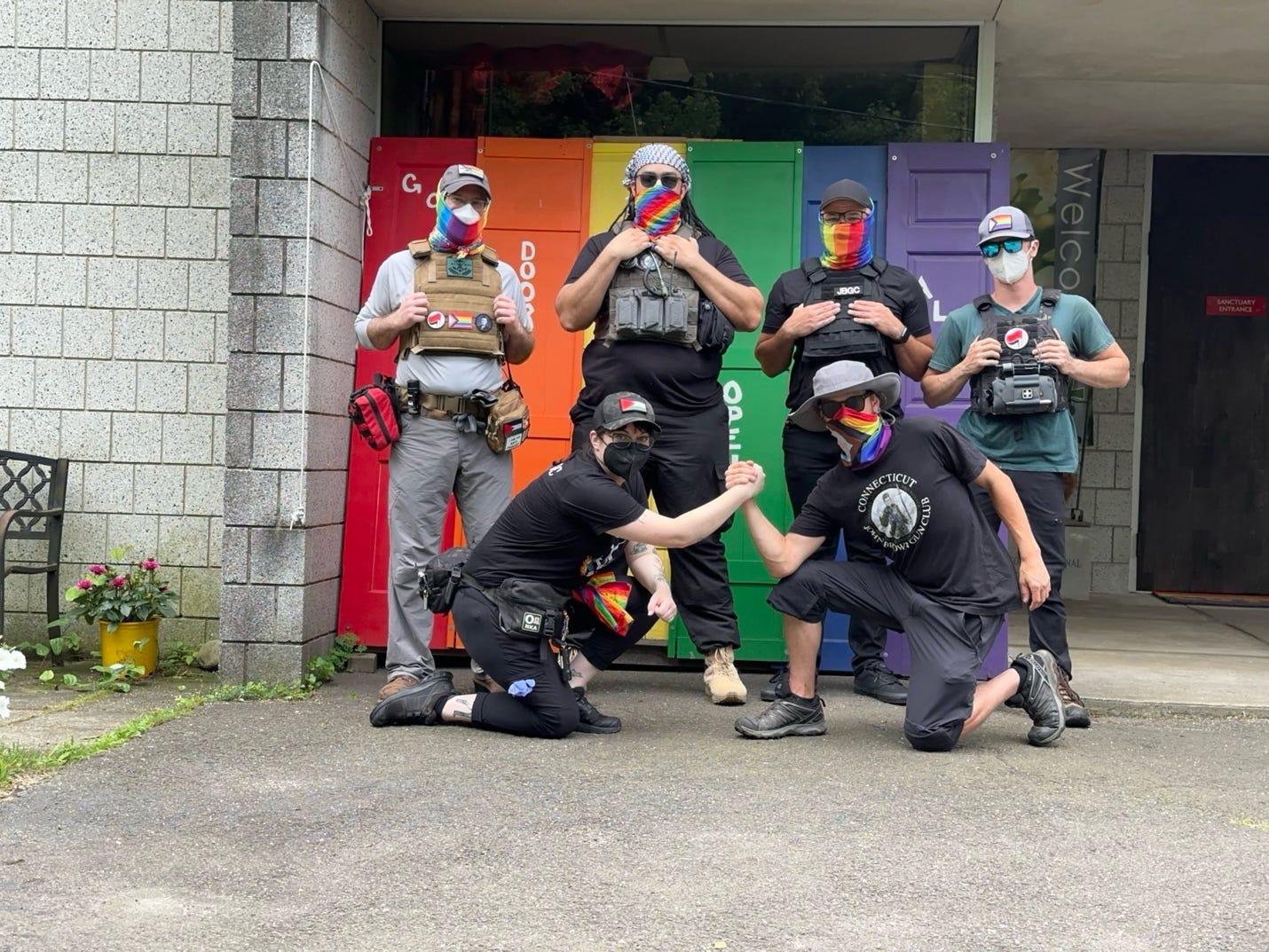 A group of people wearing masks and holding hands together

AI-generated content may be incorrect.