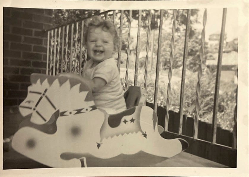 A baby sitting on a rocking horse

AI-generated content may be incorrect.