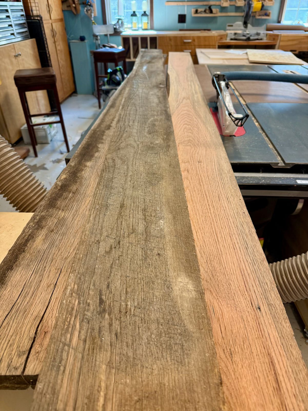 Rough-sawn red and white oak boards await milling.