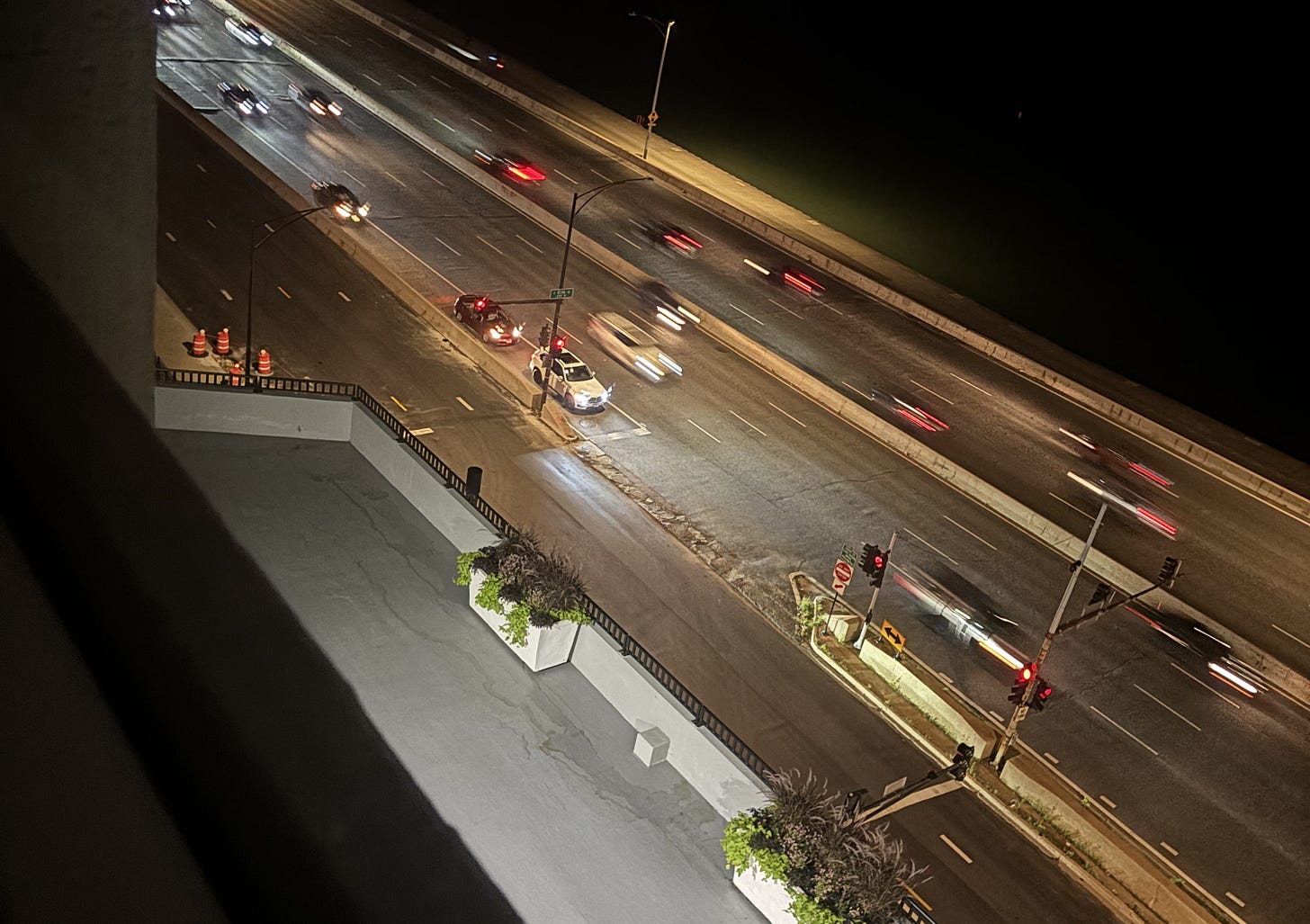 Traffic rushing past each other in the night on an eight-lane avenue