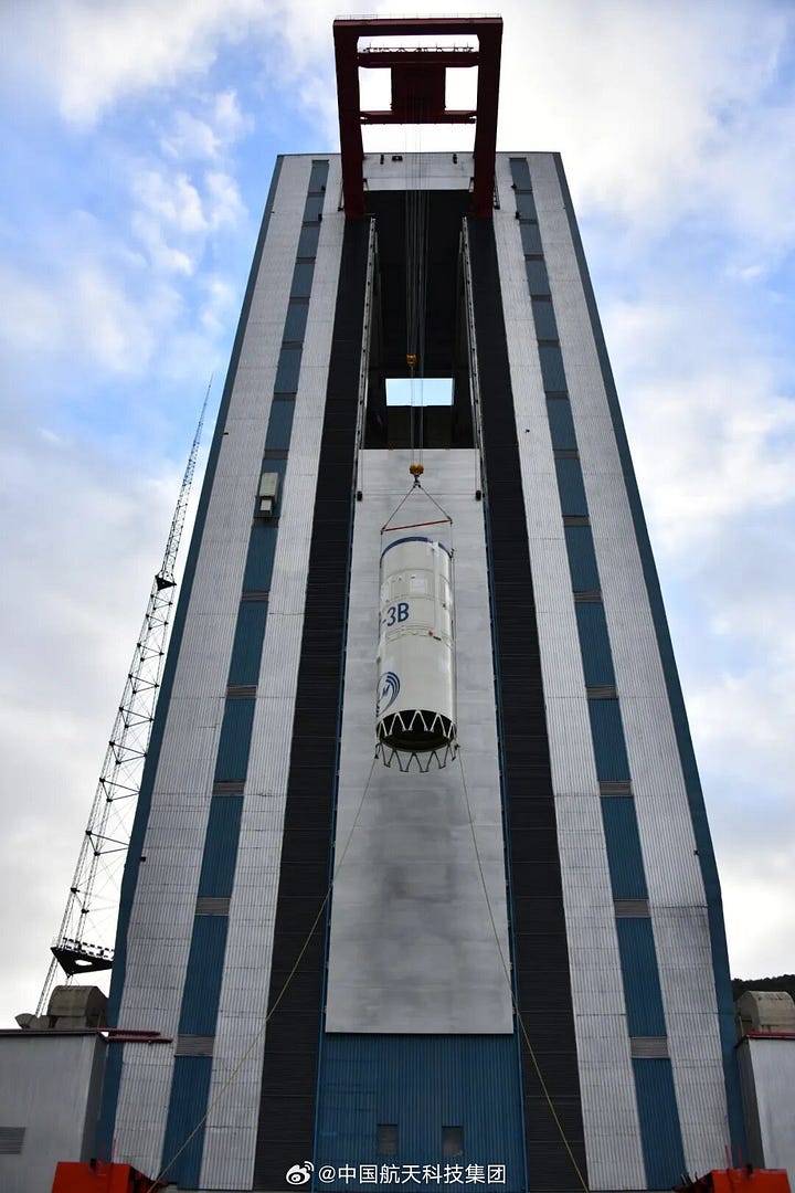 The Long March 3B/E's first-stage and second-stage being placed onto Launch Complex 2 by its rolling vertical assembly building.