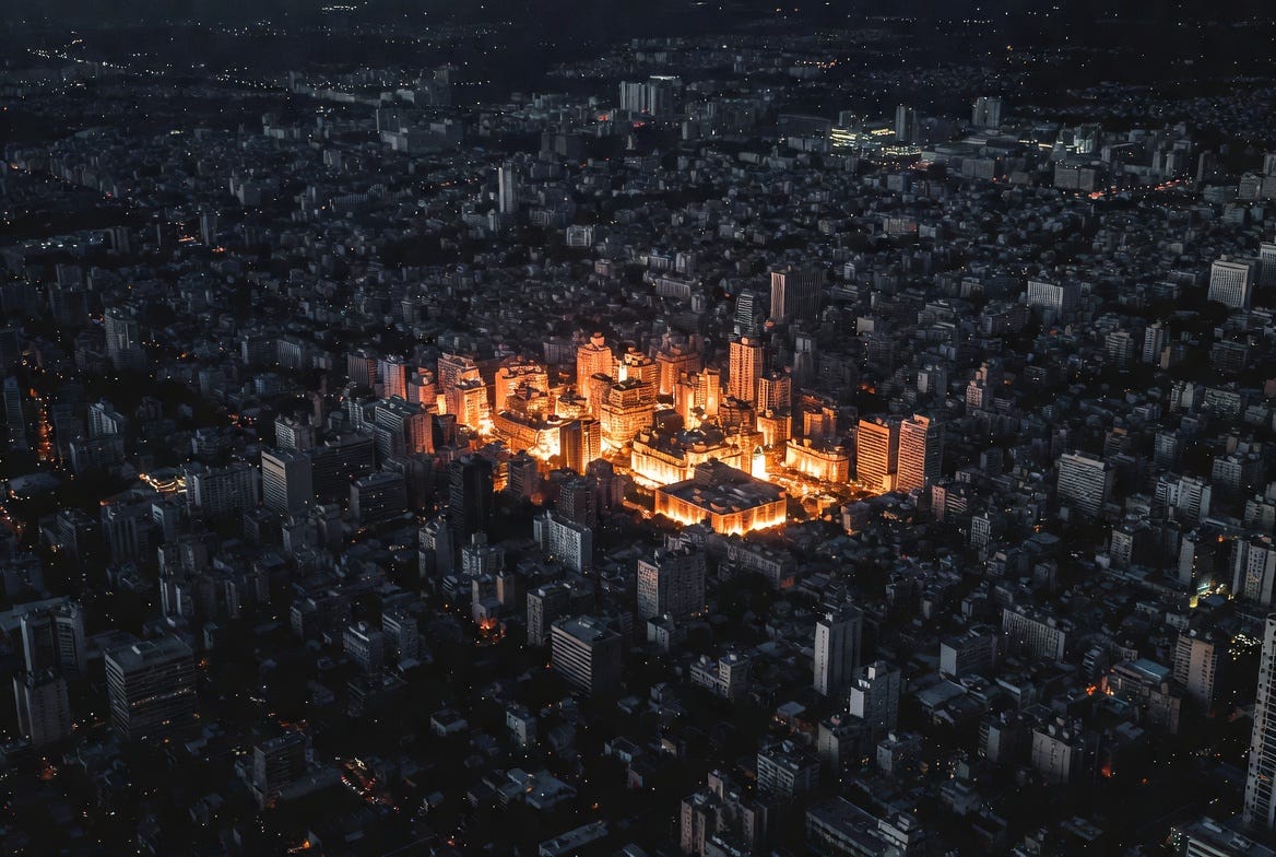 Aerial night view of a dark city with scattered clusters of buildings glowing amber, representing concentrated and exposed Bitcoin wallet holdings among a vast darkened landscape. Aerial night view of a dark city with scattered clusters of buildings glowing amber, representing concentrated and exposed Bitcoin wallet holdings among a vast darkened landscape.