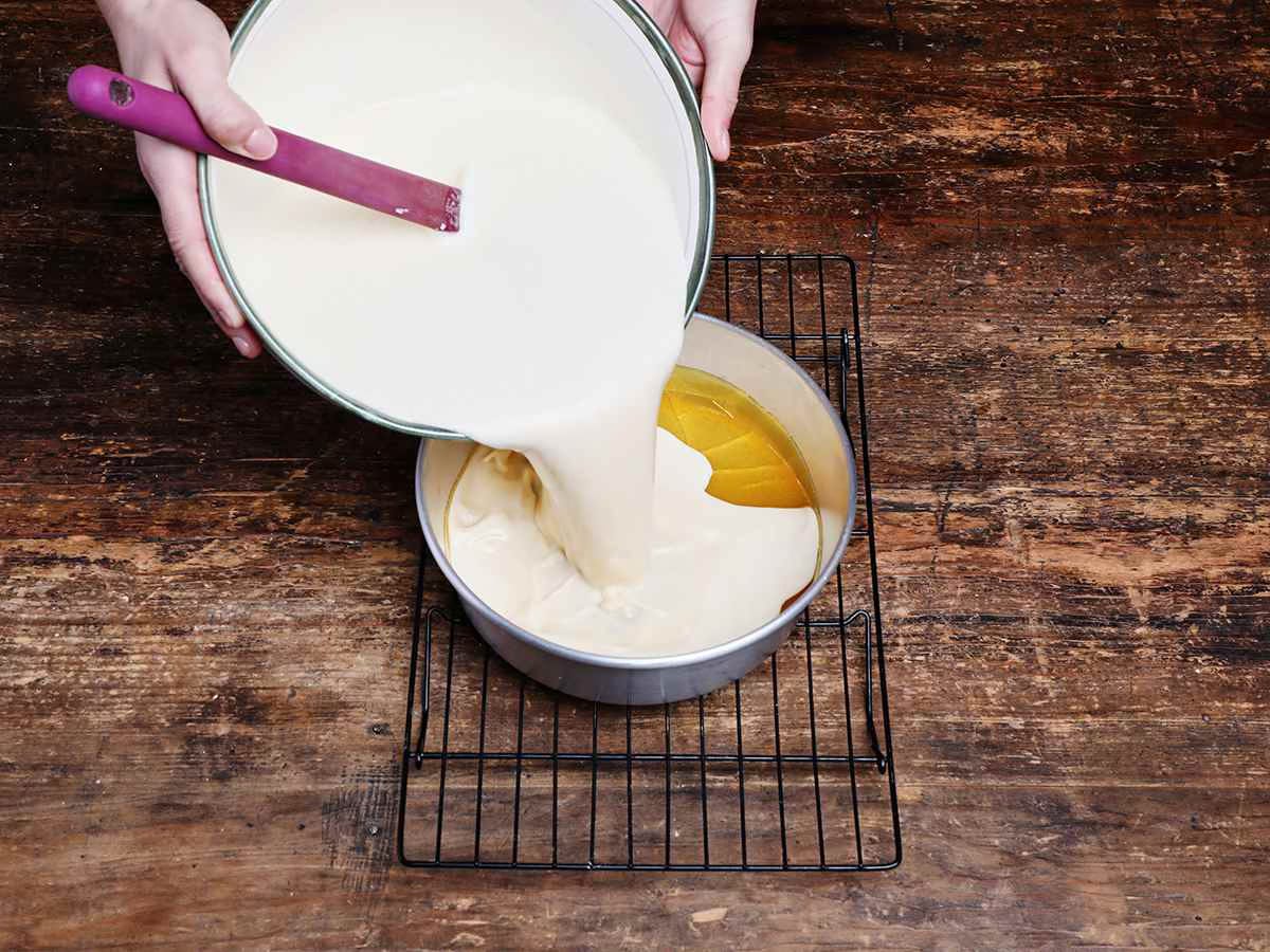 pouring flan mixture into baking dish pouring flan mixture into baking dish