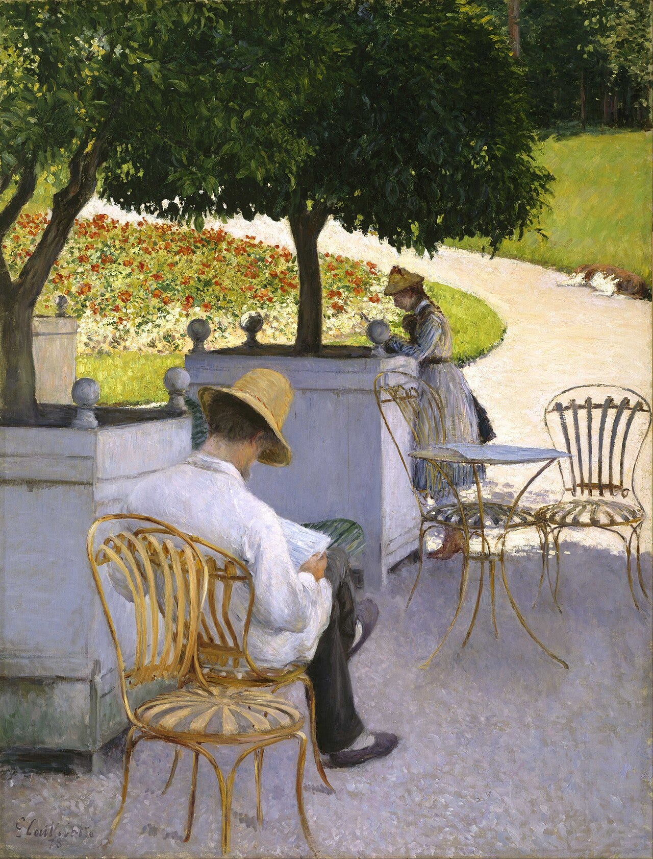 A man reading in the shade among potted orange trees A man reading in the shade among potted orange trees