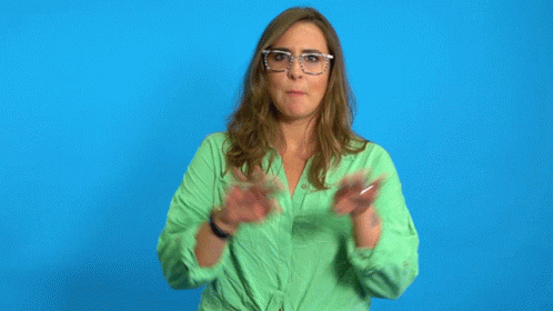 a woman in a green shirt is standing in front of a blue background with the word chill written on it