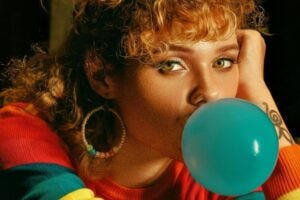 woman blowing a chewing gum bubble