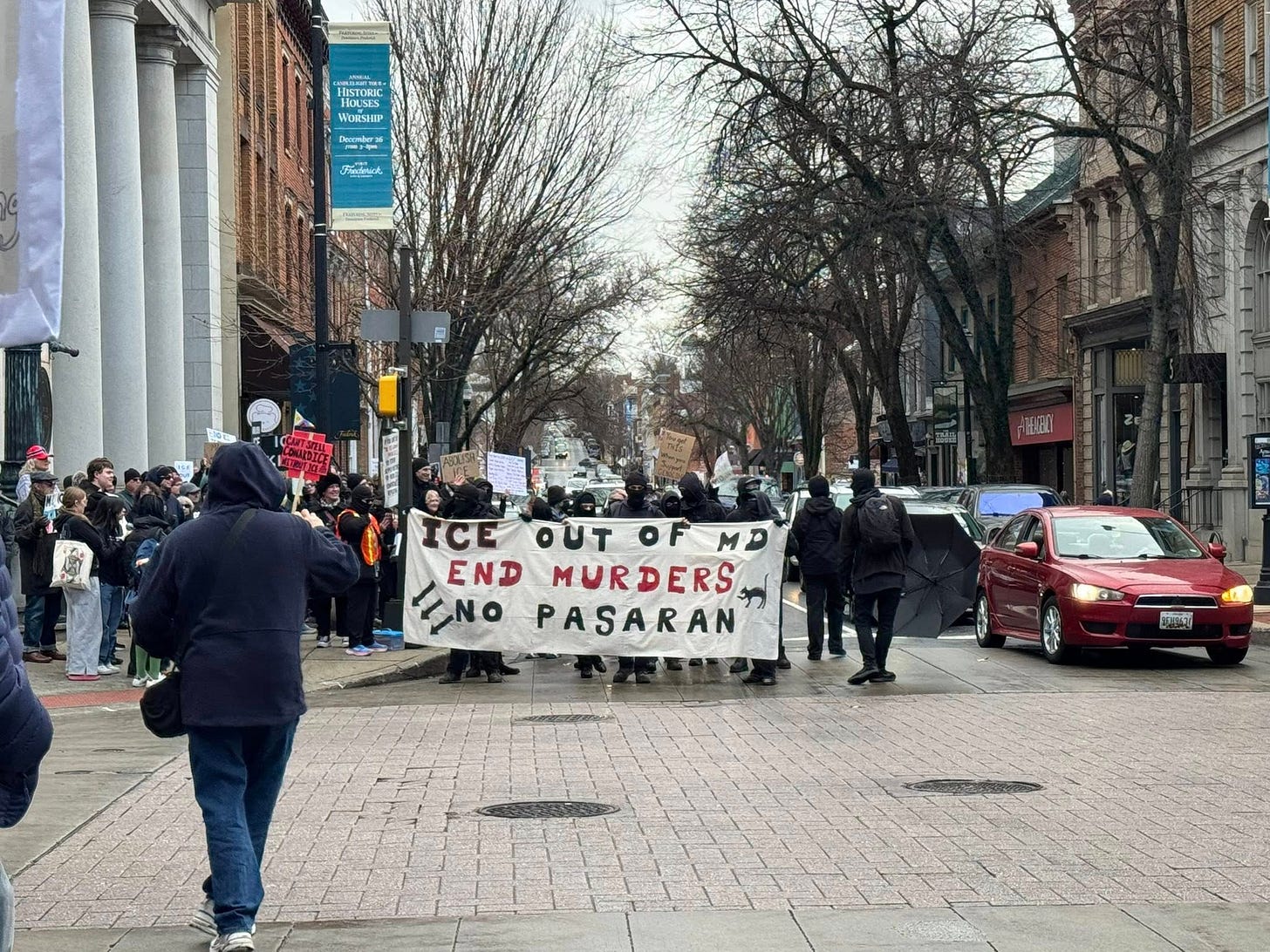 May be an image of crowd and text that says 'DSTORIC OKK HOUSES HOLVS Woesalip a おん "ត ICE OUT OF OUTOFMD MD END MURDERS INO PASARAN'