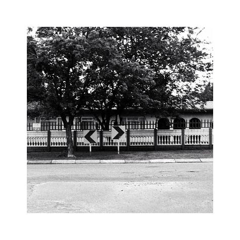 Two chevron boards, A business sign and blurred lights in a restaurant.