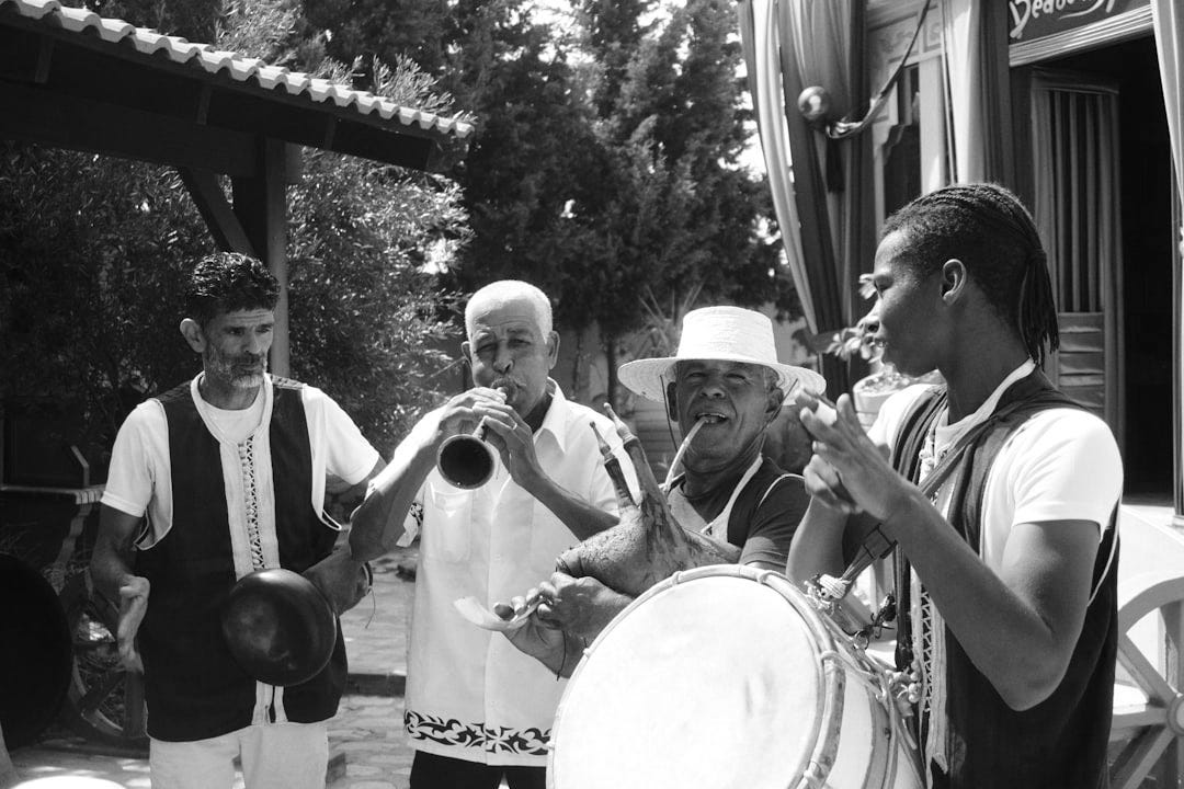 Group of men playing musical instruments outdoors