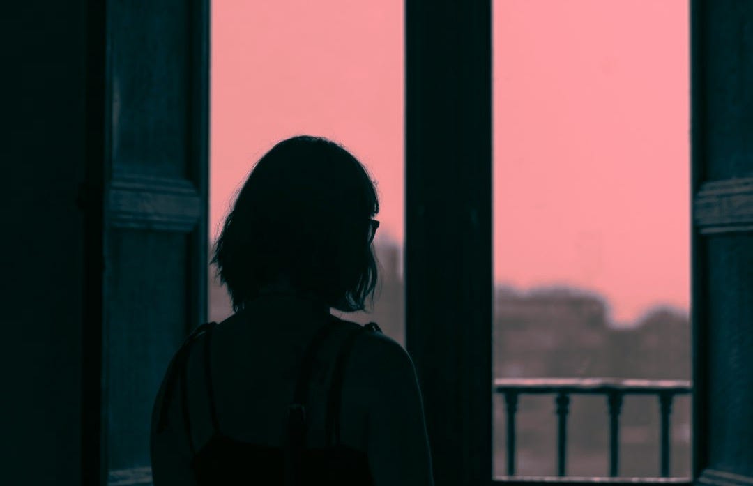 woman standing in front of window