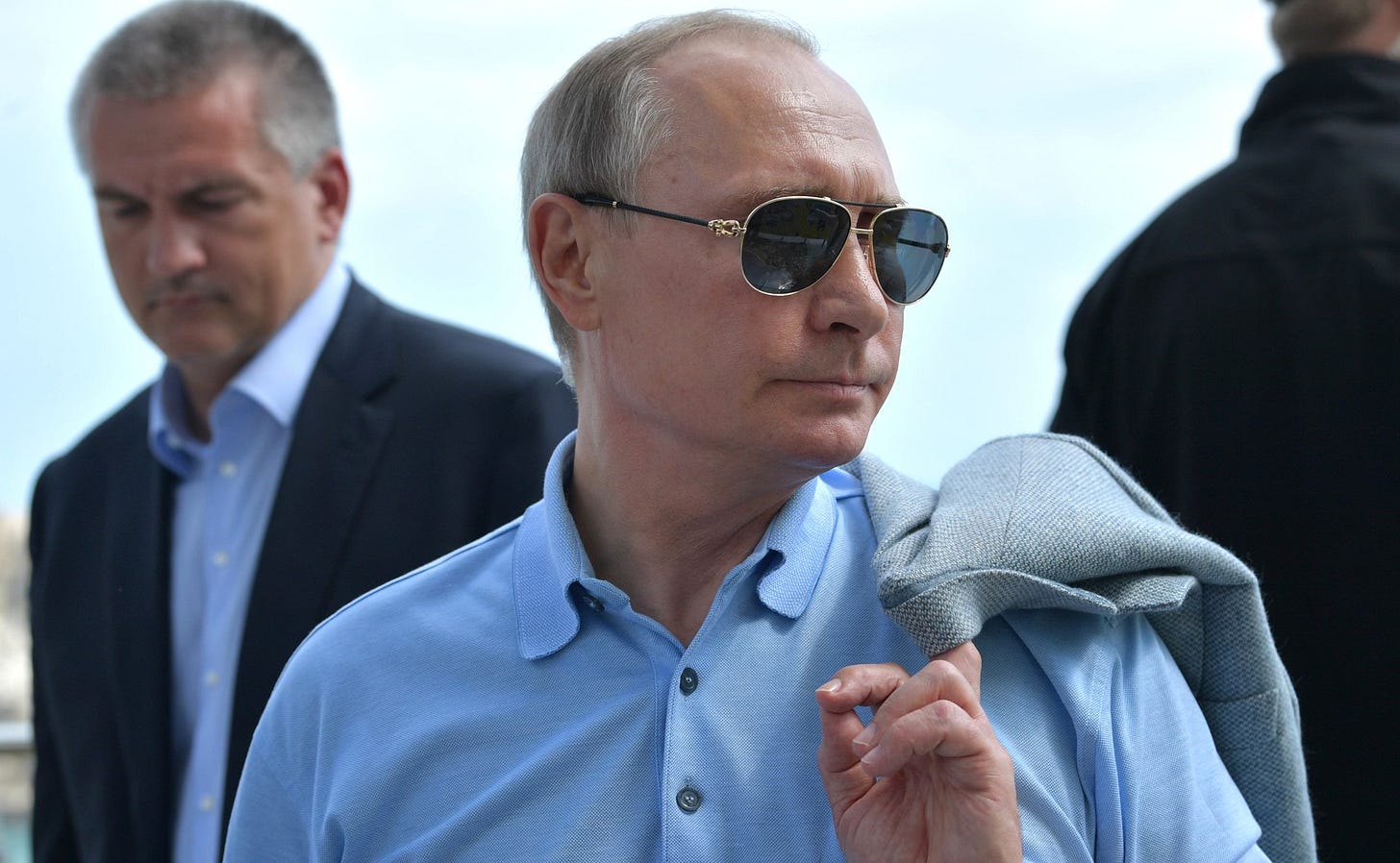 Vladimir Putin in blue shirt and sunglasses