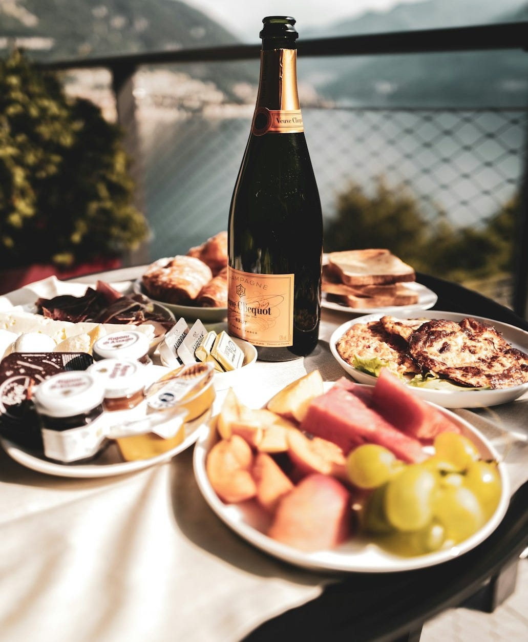 a bottle of wine sitting on top of a table filled with food a bottle of wine sitting on top of a table filled with food