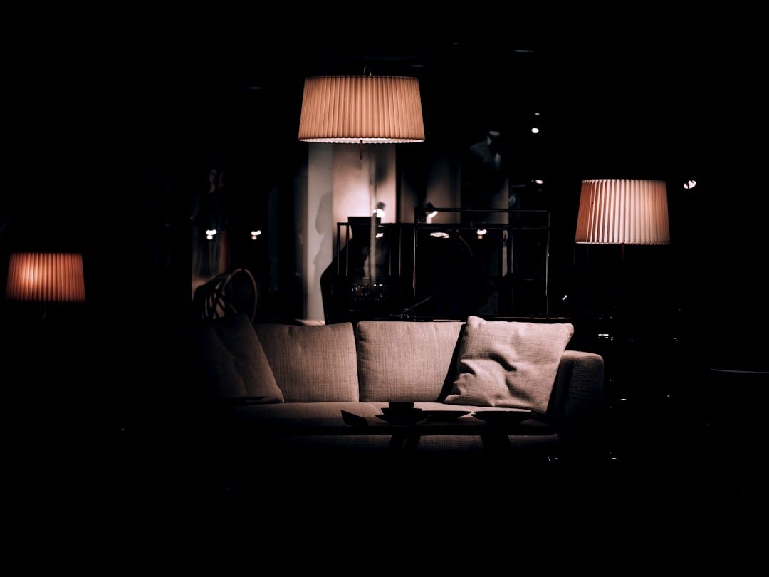 a living room with a couch and lamps