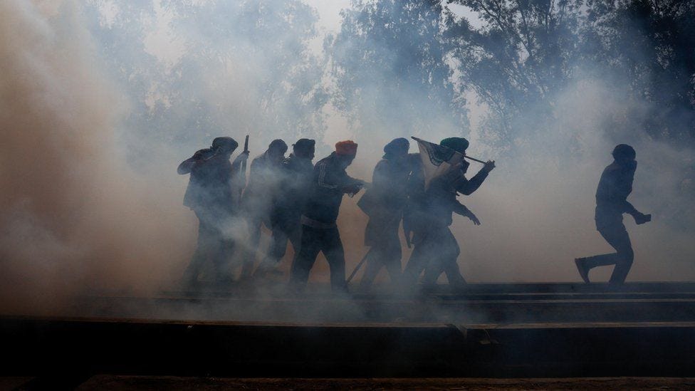 Farmers, who are marching towards New Delhi to press for better crop prices promised to them in 2021, run for cover amidst tear gas fired by police to disperse them at Shambhu barrier, a border crossing between Punjab and Haryana states, India, February 21, 2024. Farmers, who are marching towards New Delhi to press for better crop prices promised to them in 2021, run for cover amidst tear gas fired by police to disperse them at Shambhu barrier, a border crossing between Punjab and Haryana states, India, February 21, 2024.