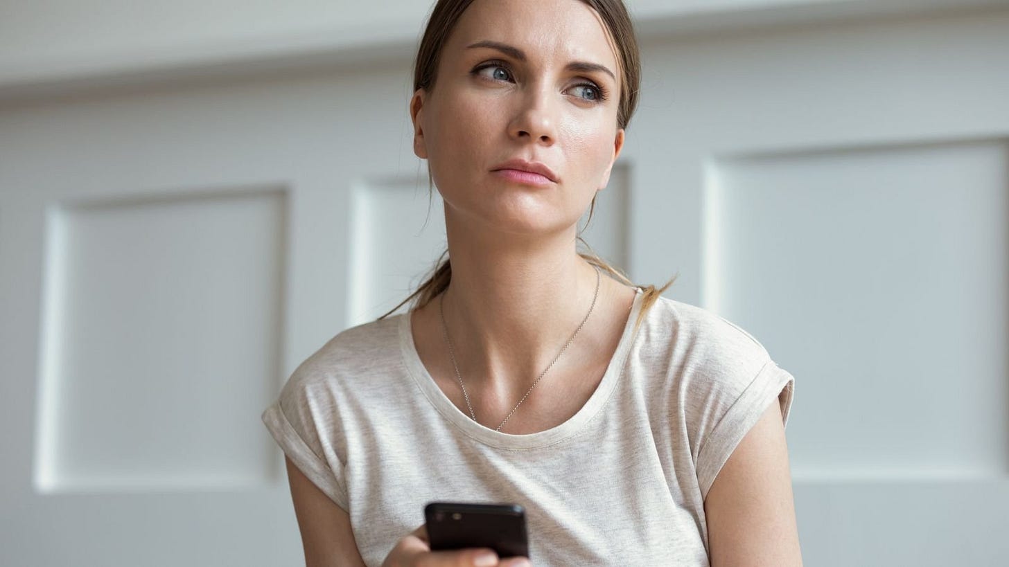woman phone sad think