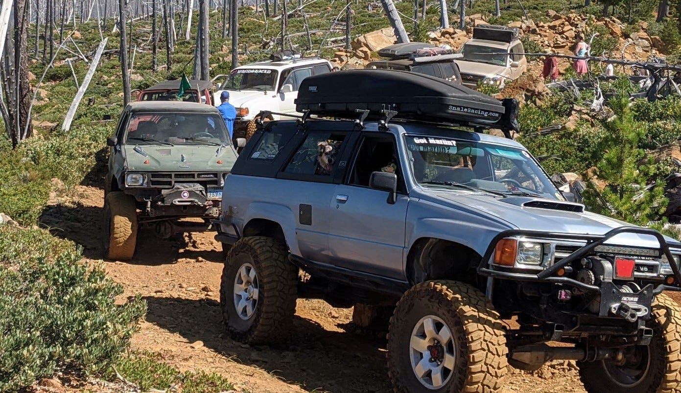 trucks following a forest path