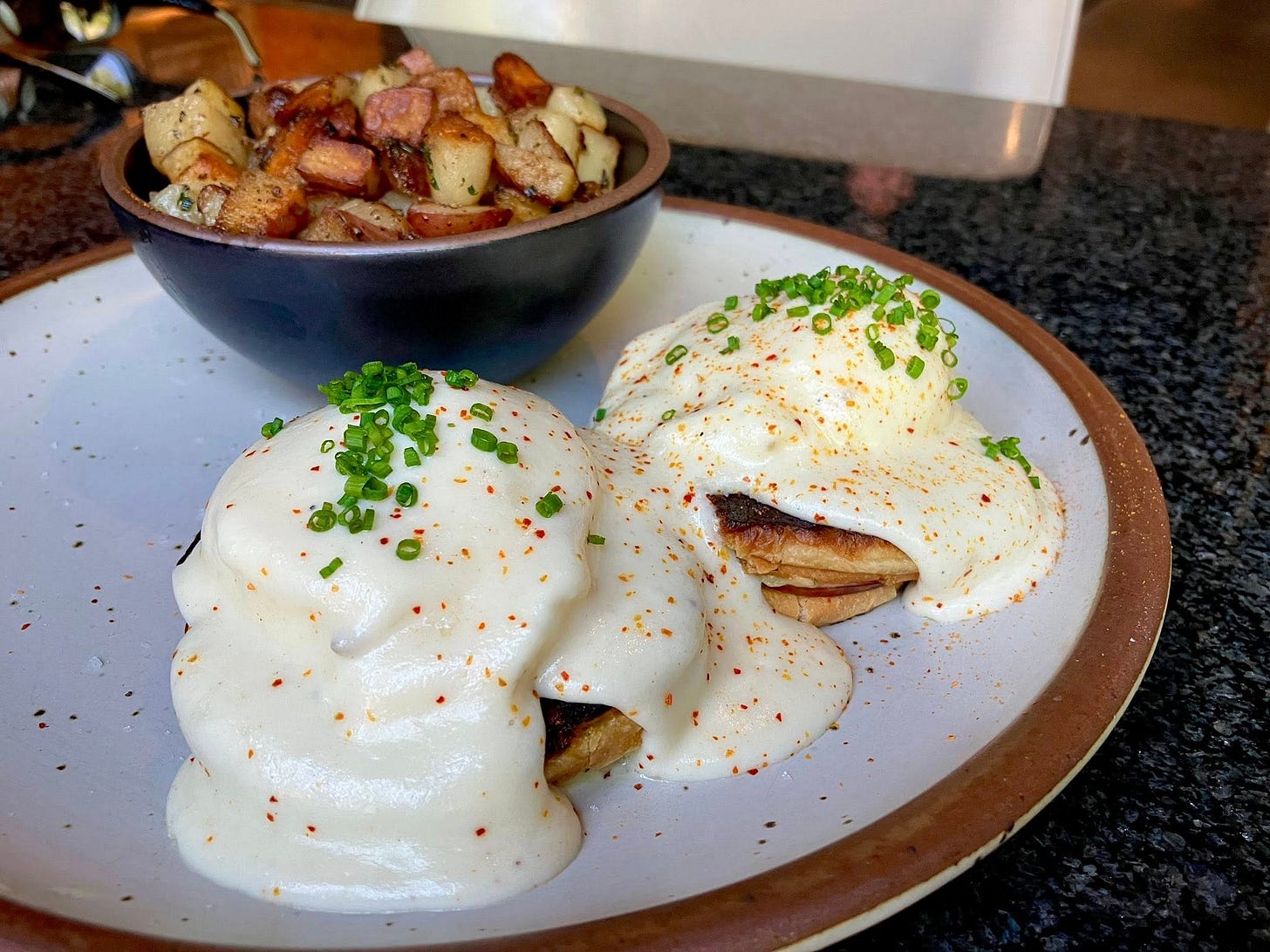 May be an image of english muffin, egg yolk and poached egg