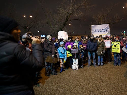 group of protesters holding signs at night group of protesters holding signs at night