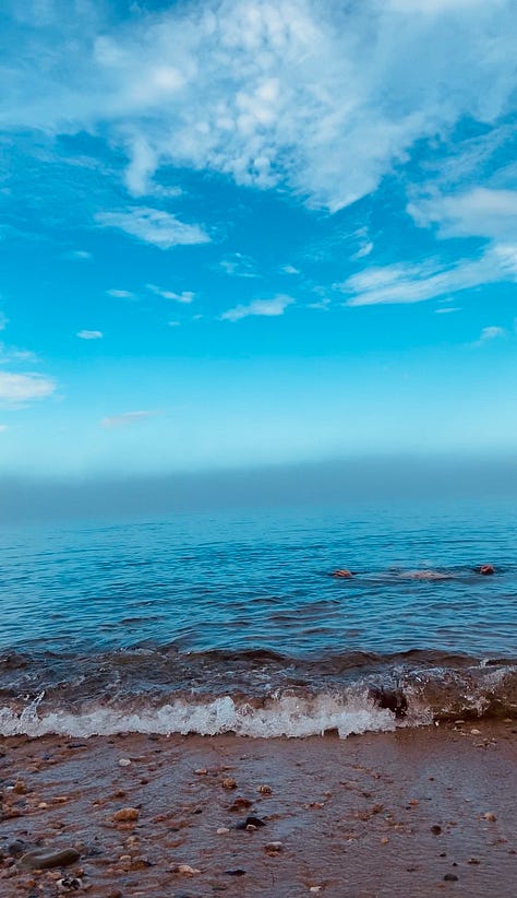 three photos of a person emerging into the ocean's calm blue water