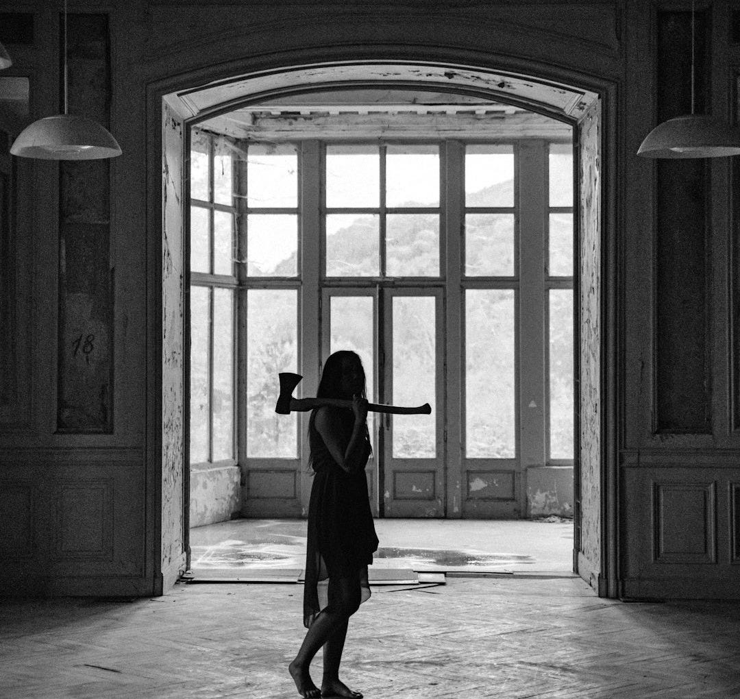 woman in black long sleeve shirt and red skirt standing in front of brown wooden door