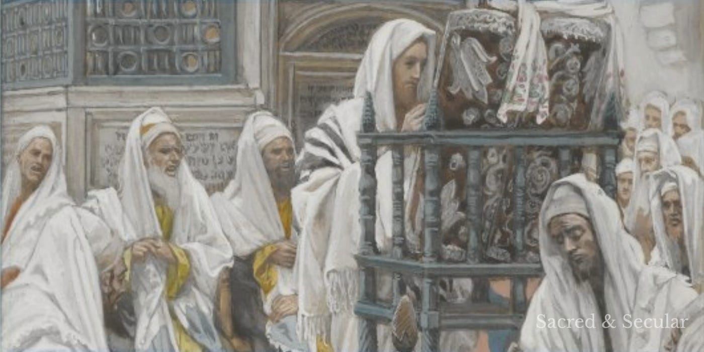 Alt image description: James Tissot’s painting shows Jesus standing in a synagogue, reading from an open scroll before a gathered crowd. Men sit and stand closely around him, watching and listening as he teaches in the familiar setting of his hometown. Alt image description: James Tissot’s painting shows Jesus standing in a synagogue, reading from an open scroll before a gathered crowd. Men sit and stand closely around him, watching and listening as he teaches in the familiar setting of his hometown.