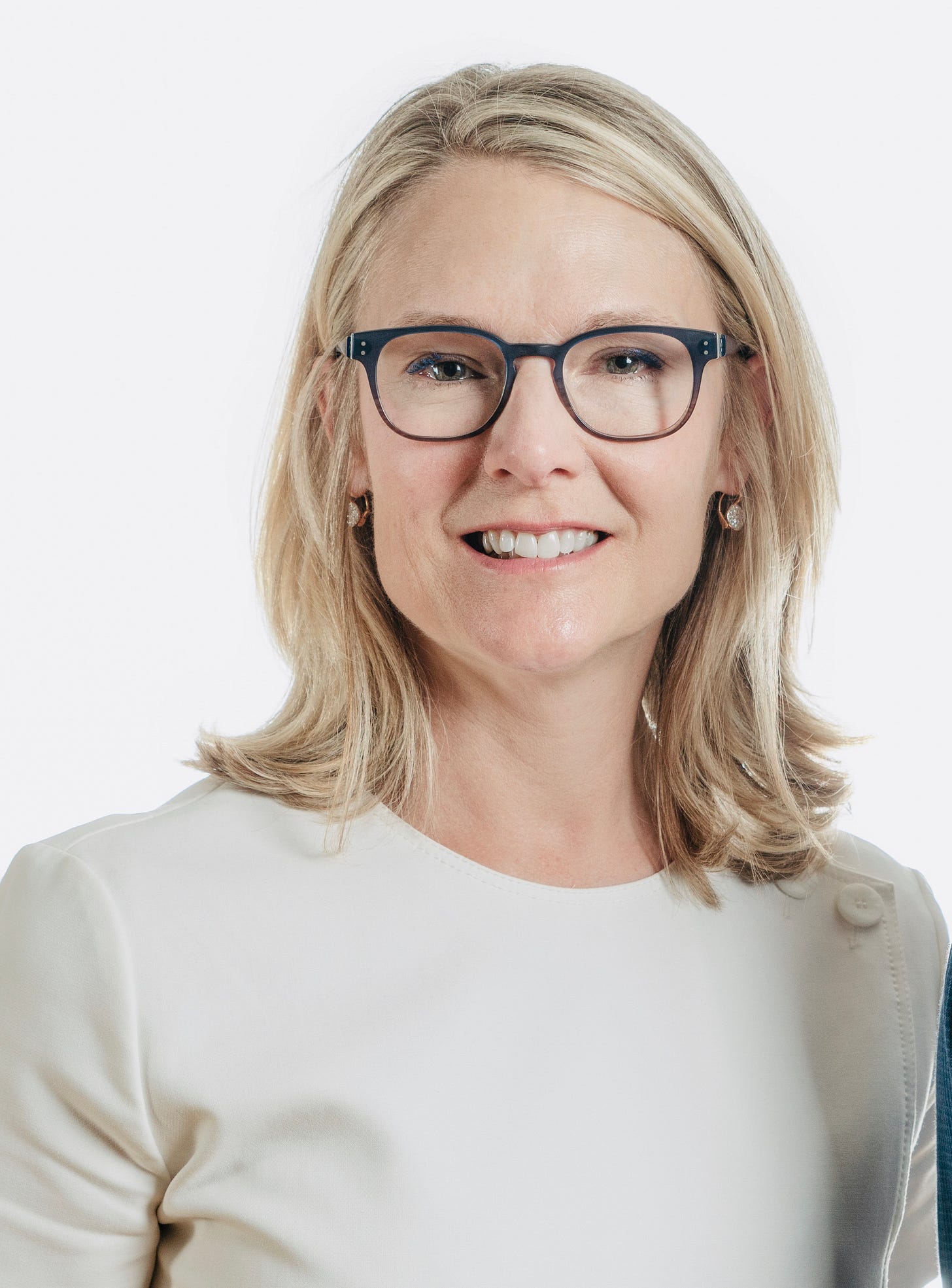 Lauren Driscoll, Founder & CEO of NourishedRX in white shirt and black glasses